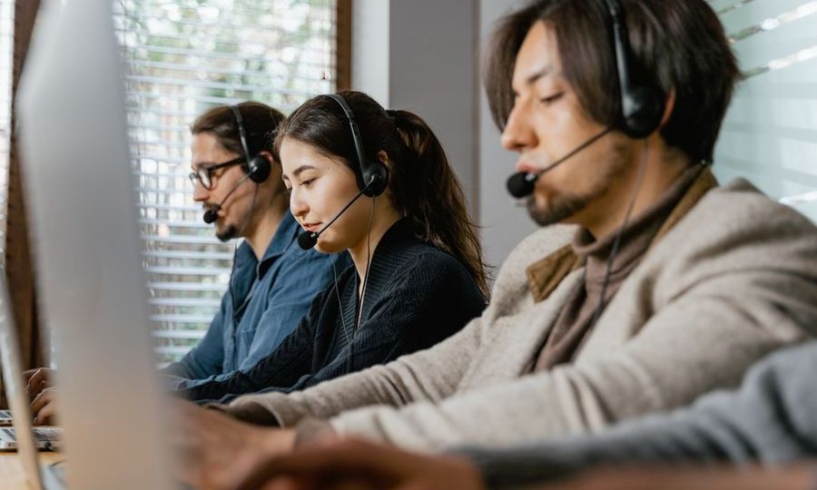 Customer service team wearing headsets in an office